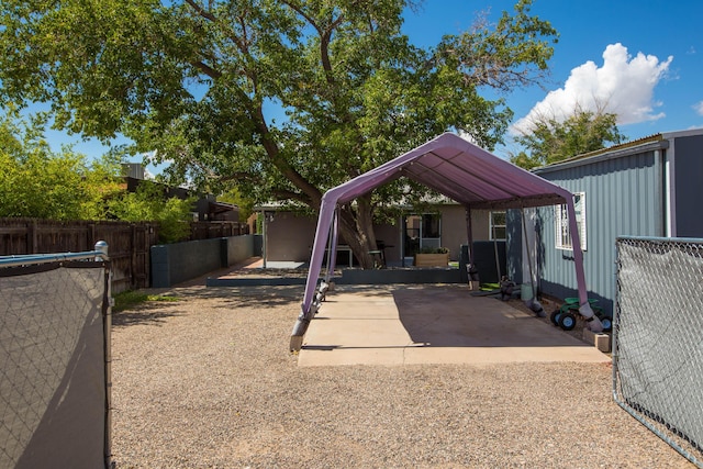 exterior space with a carport and fence