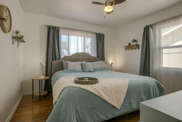 bedroom featuring ceiling fan, dark wood-type flooring, and baseboards