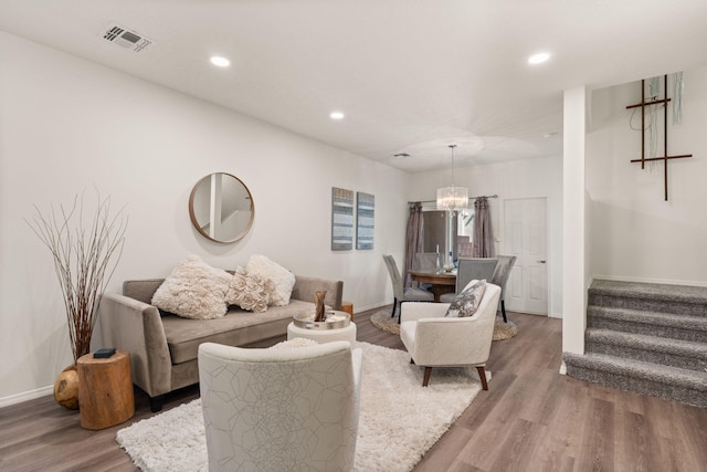 living room with recessed lighting, visible vents, a notable chandelier, and wood finished floors