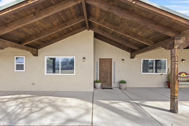 entrance to property featuring stucco siding and a patio