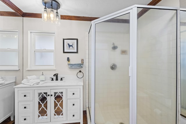 bathroom featuring a chandelier, a shower stall, and vanity