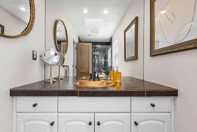 full bath featuring a stall shower and vanity