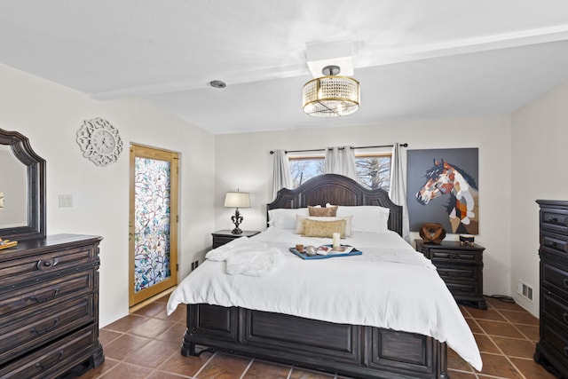 bedroom featuring dark tile patterned floors and visible vents