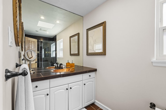 full bathroom featuring vanity, recessed lighting, baseboards, and a shower with door