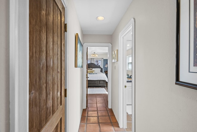 hallway with tile patterned flooring