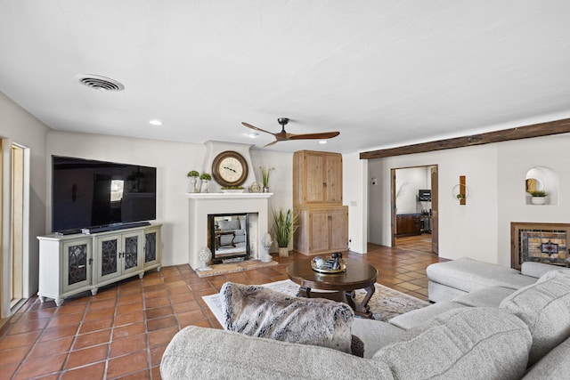 tiled living room with recessed lighting, a glass covered fireplace, ceiling fan, and visible vents