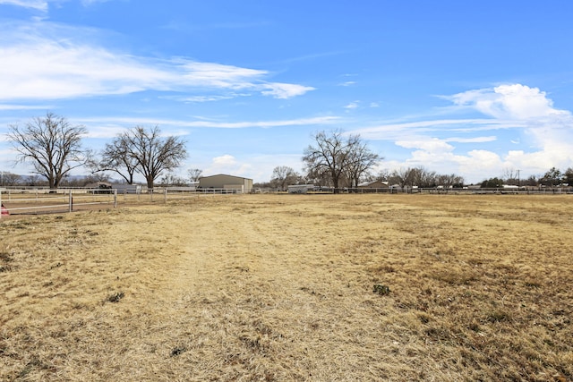 view of yard with a rural view and fence