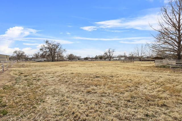 view of yard featuring a rural view and fence