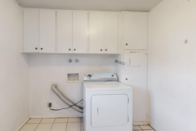 laundry area with light tile patterned flooring, cabinet space, and washer / clothes dryer