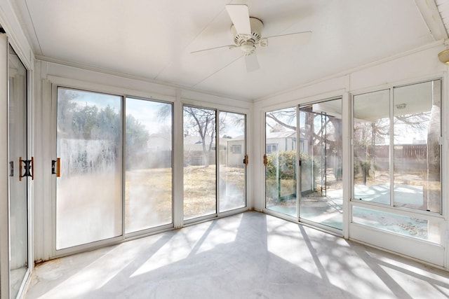 unfurnished sunroom featuring a wealth of natural light and a ceiling fan