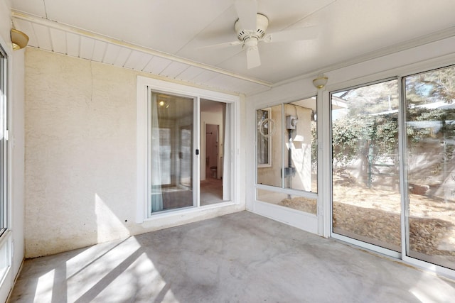 unfurnished sunroom featuring ceiling fan