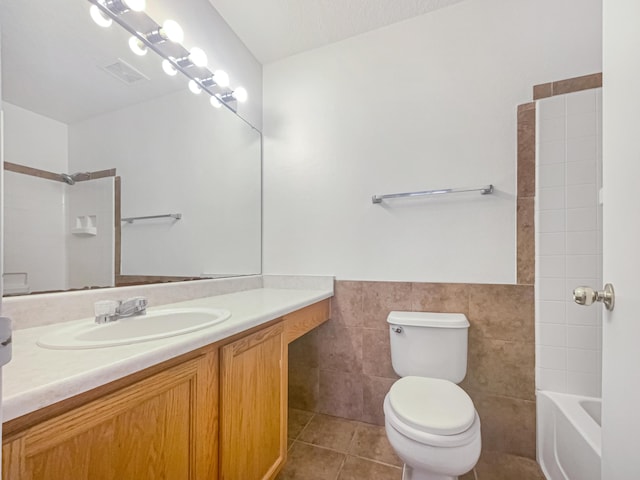 bathroom with vanity, visible vents, tile patterned flooring, tile walls, and toilet