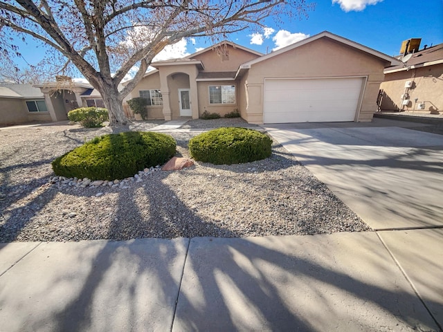 view of front of home featuring stucco siding, driveway, and an attached garage