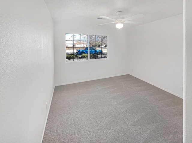 carpeted empty room with baseboards and ceiling fan