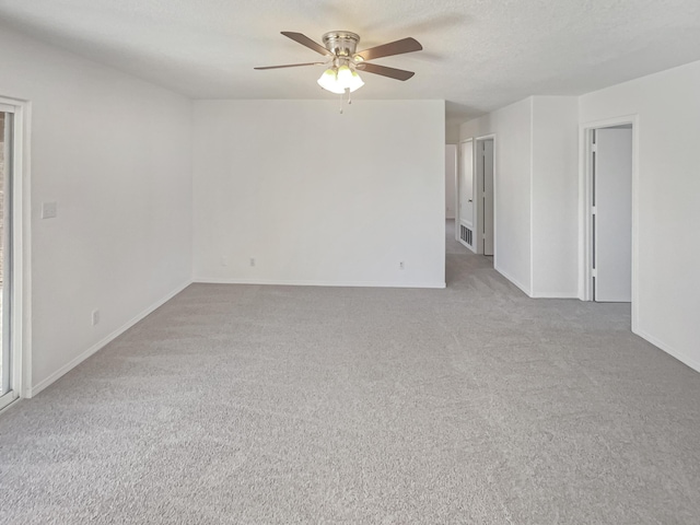 unfurnished room with visible vents, a ceiling fan, a textured ceiling, carpet, and baseboards