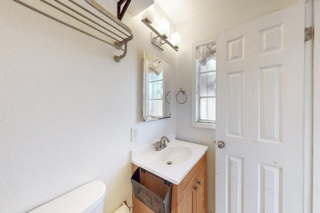 half bathroom with toilet and vanity