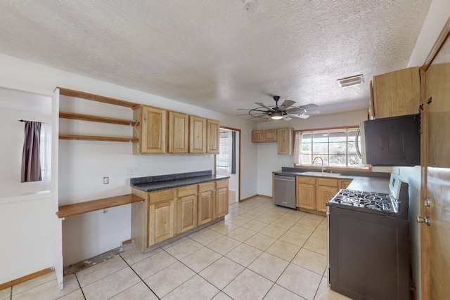 kitchen featuring white microwave, visible vents, ceiling fan, range with gas stovetop, and stainless steel dishwasher