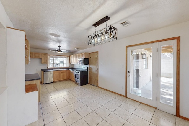 kitchen with visible vents, light brown cabinets, a sink, dark countertops, and stainless steel appliances