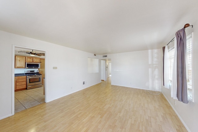 unfurnished living room with light wood finished floors and visible vents