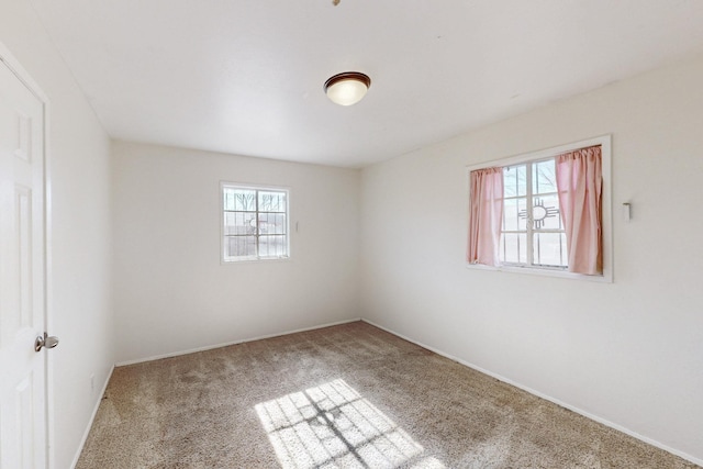 unfurnished room with baseboards and carpet floors