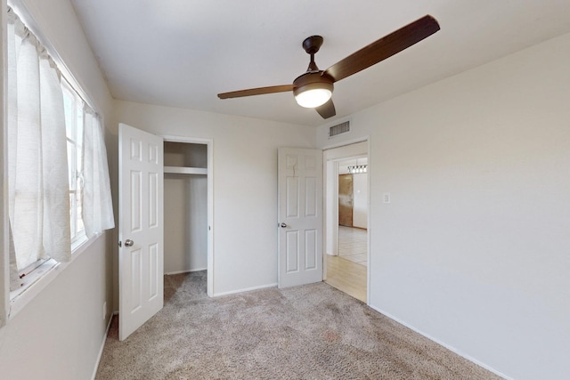 unfurnished bedroom with visible vents, baseboards, carpet, a closet, and a ceiling fan