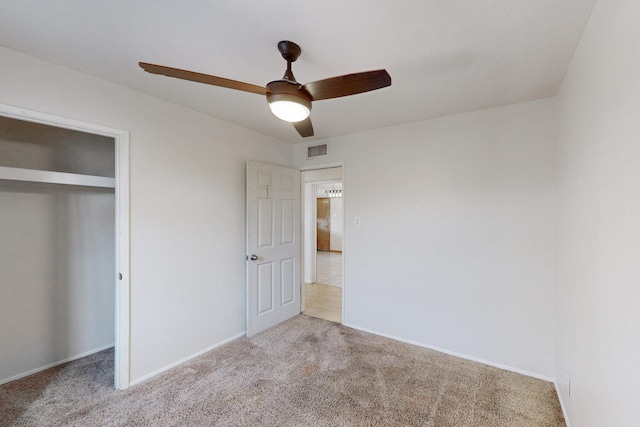 unfurnished bedroom featuring visible vents, a ceiling fan, a closet, carpet, and baseboards