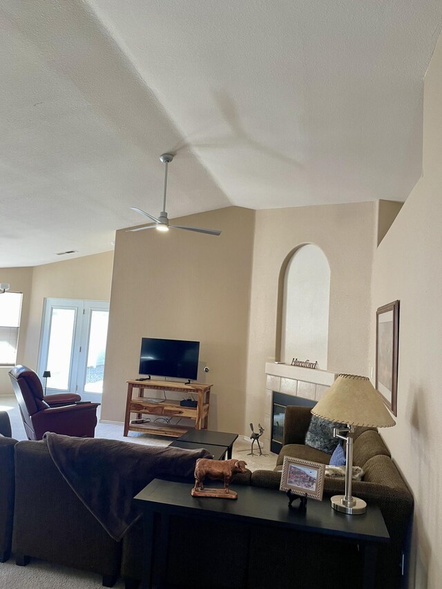 carpeted living room featuring visible vents, a textured ceiling, a ceiling fan, and lofted ceiling