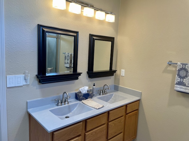 bathroom featuring a sink and double vanity