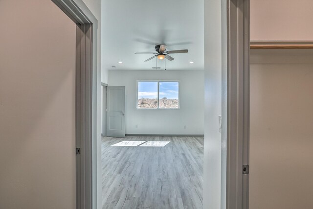 corridor featuring recessed lighting, wood finished floors, and baseboards