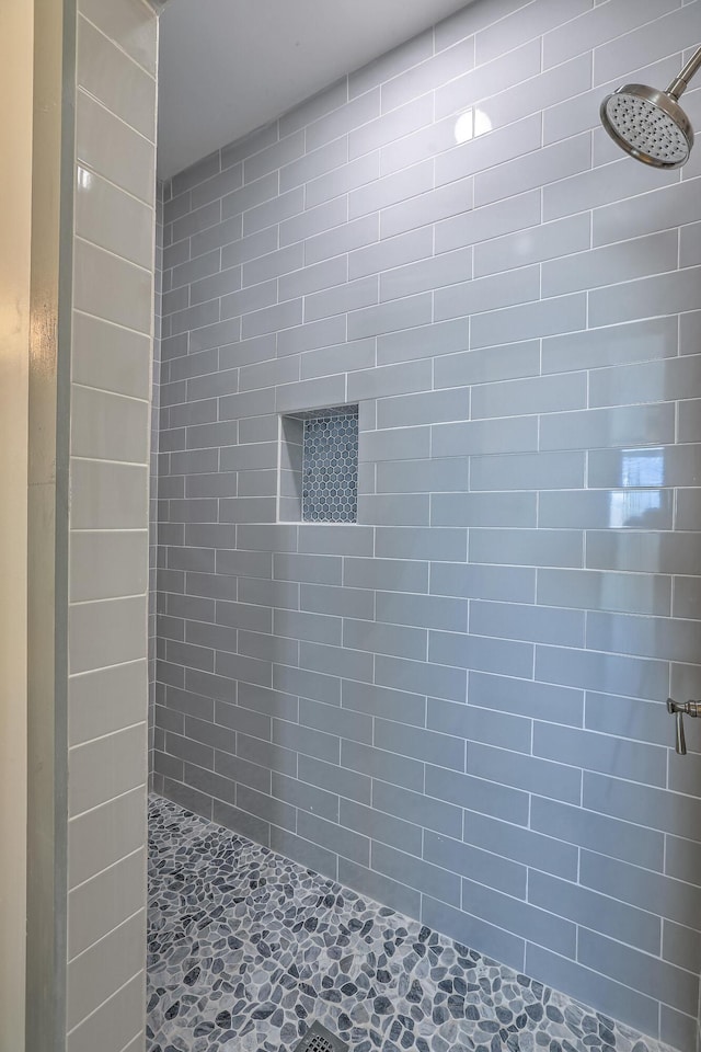 bathroom with a tile shower