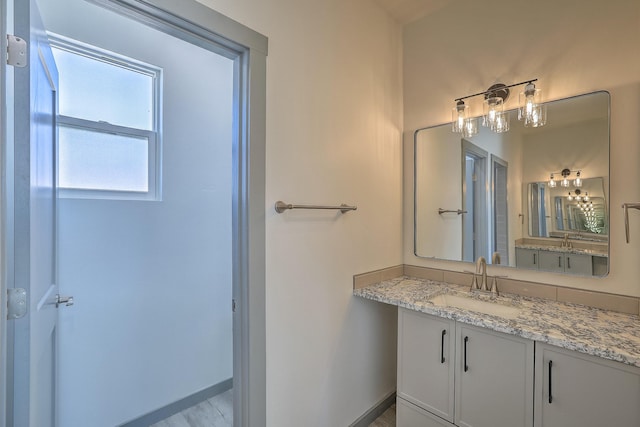 bathroom featuring baseboards and vanity