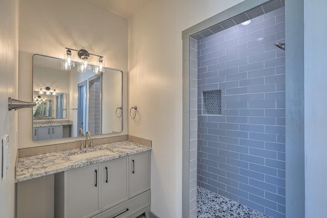bathroom with walk in shower and vanity