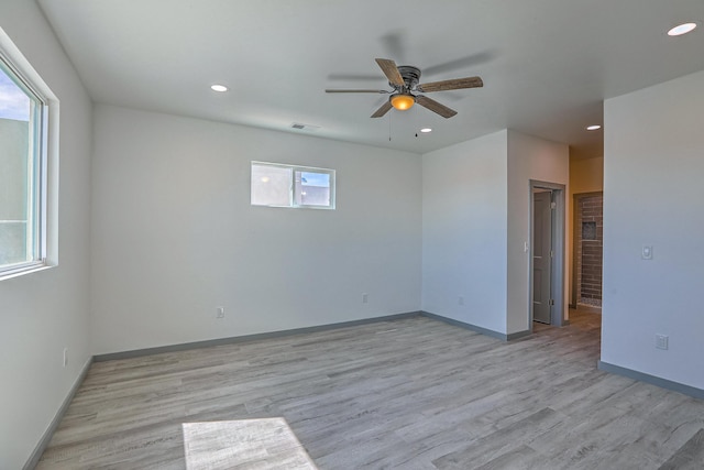 spare room with recessed lighting, light wood finished floors, visible vents, a ceiling fan, and baseboards