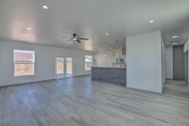 unfurnished living room with recessed lighting, light wood-style floors, and ceiling fan