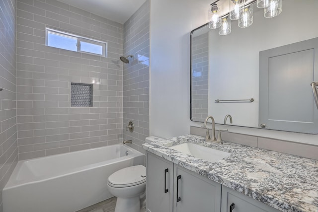 bathroom featuring vanity, toilet, and shower / washtub combination