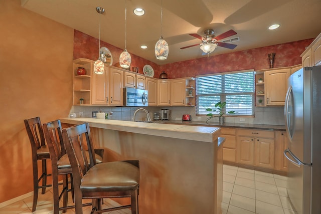 kitchen with ceiling fan, a peninsula, a kitchen breakfast bar, stainless steel appliances, and open shelves