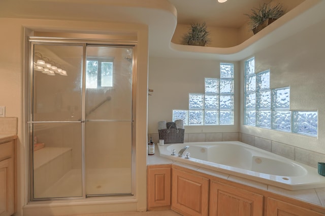 bathroom with a bath and a shower stall