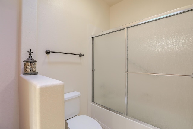 full bathroom featuring shower / bath combination with glass door and toilet