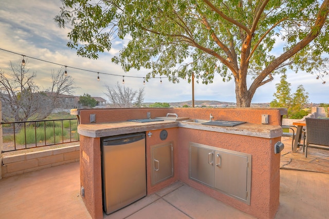 view of patio / terrace featuring exterior kitchen and fence