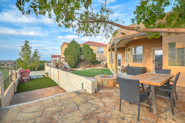 view of patio / terrace featuring outdoor dining area and an outdoor fire pit