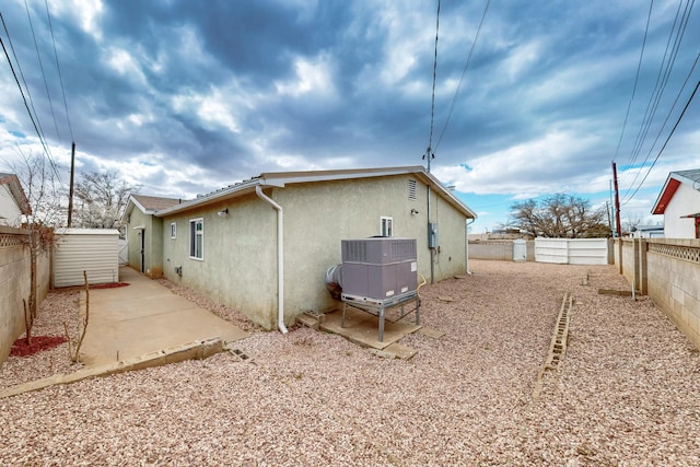 rear view of house featuring a patio, a fenced backyard, and stucco siding