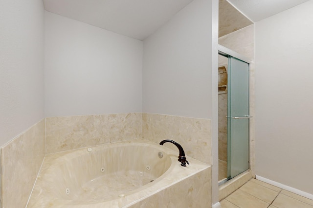 full bath with tile patterned flooring, a stall shower, and a jetted tub