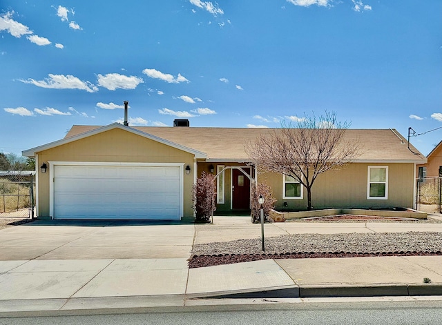 single story home featuring driveway, an attached garage, and fence