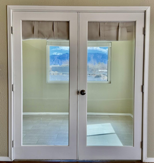 bathroom featuring french doors and baseboards