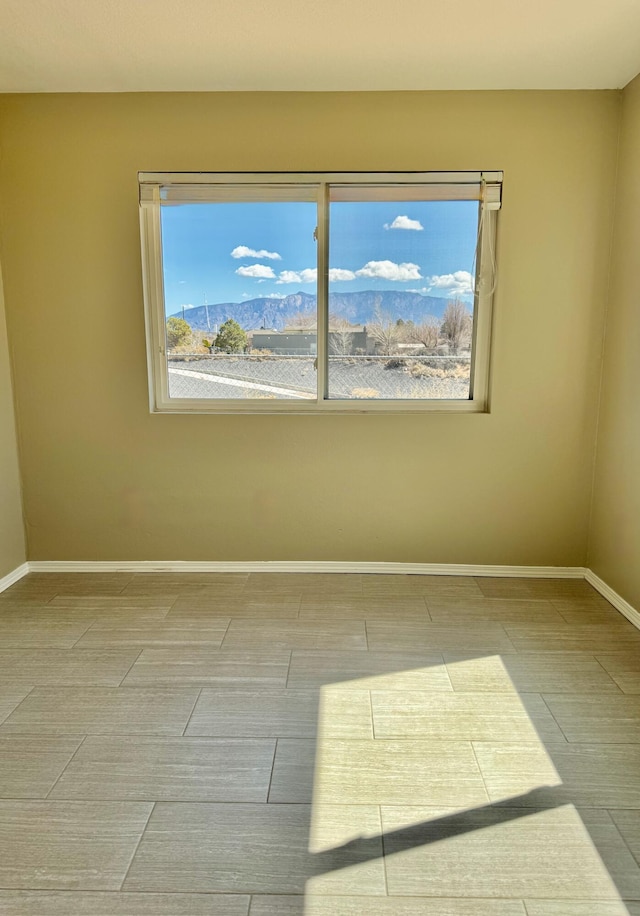 spare room featuring baseboards