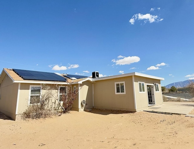 back of house with solar panels