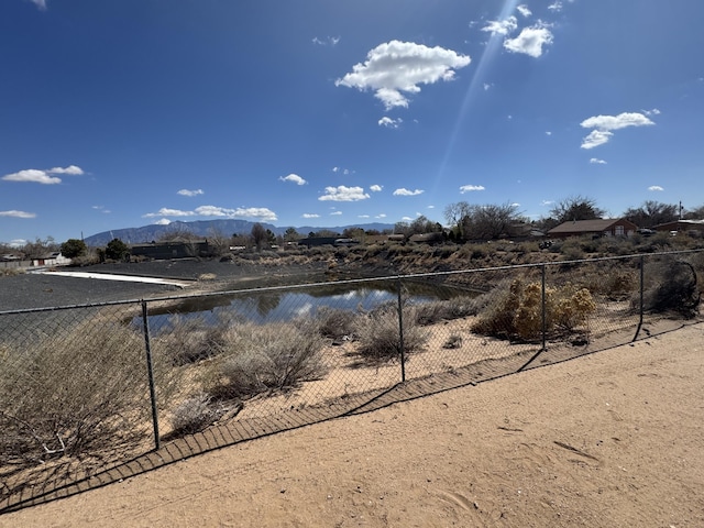 water view with fence and a mountain view