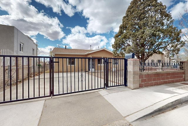 view of gate with a fenced front yard