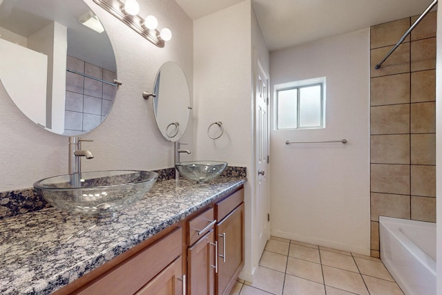 full bathroom featuring a sink, double vanity, and tile patterned floors