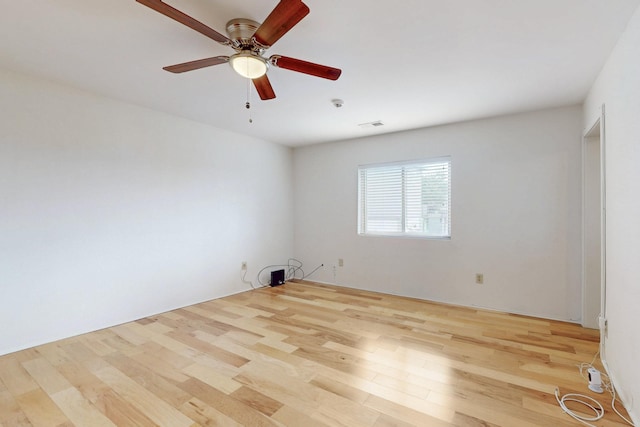 spare room featuring wood finished floors and a ceiling fan